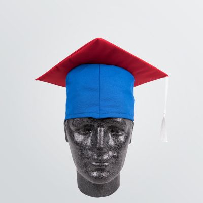 classical University Hat made of cotton for customisation depicted as a product example in blue colour with red panel and white tassel - front view